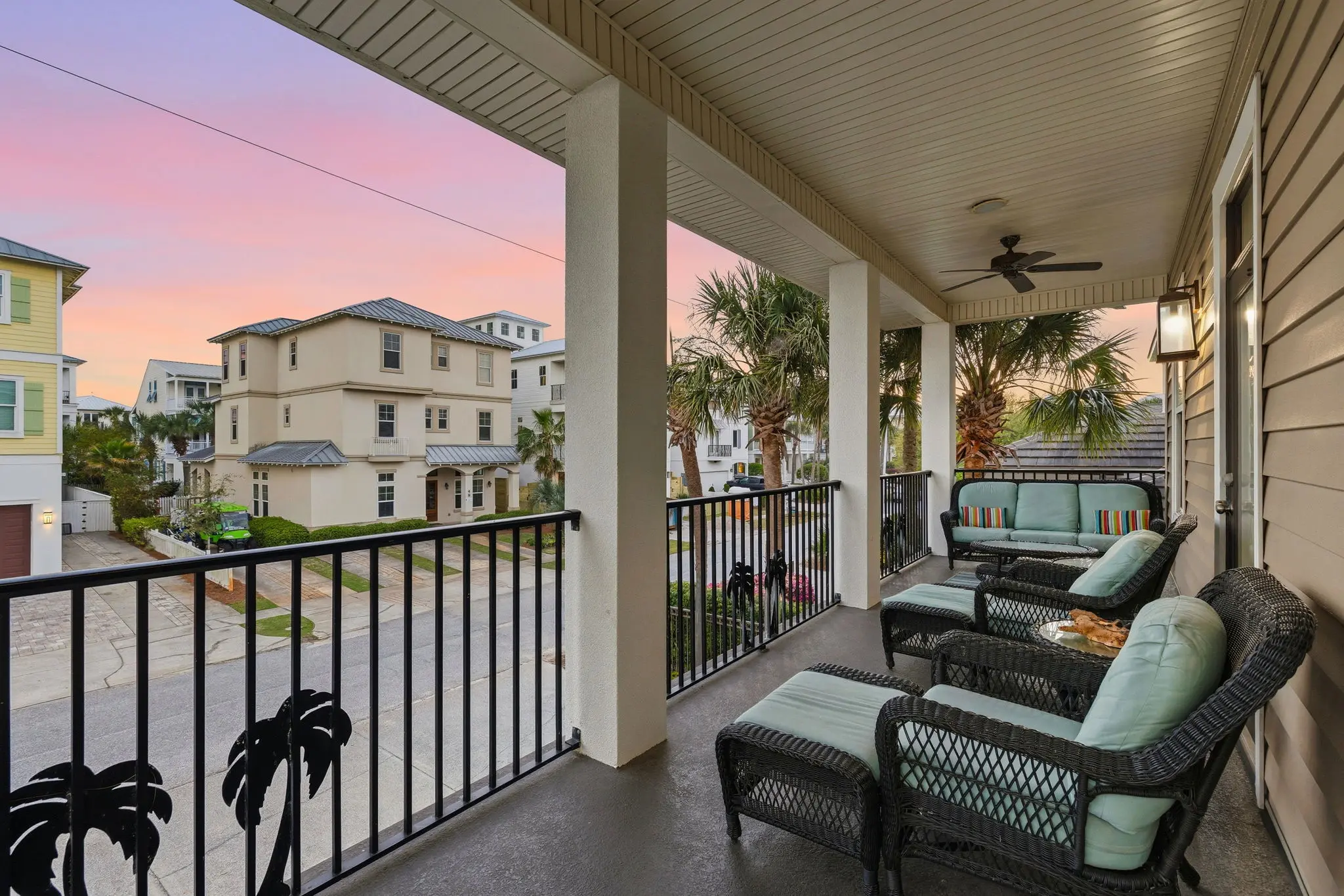 Covered balcony with wicker lounge furniture at twilight