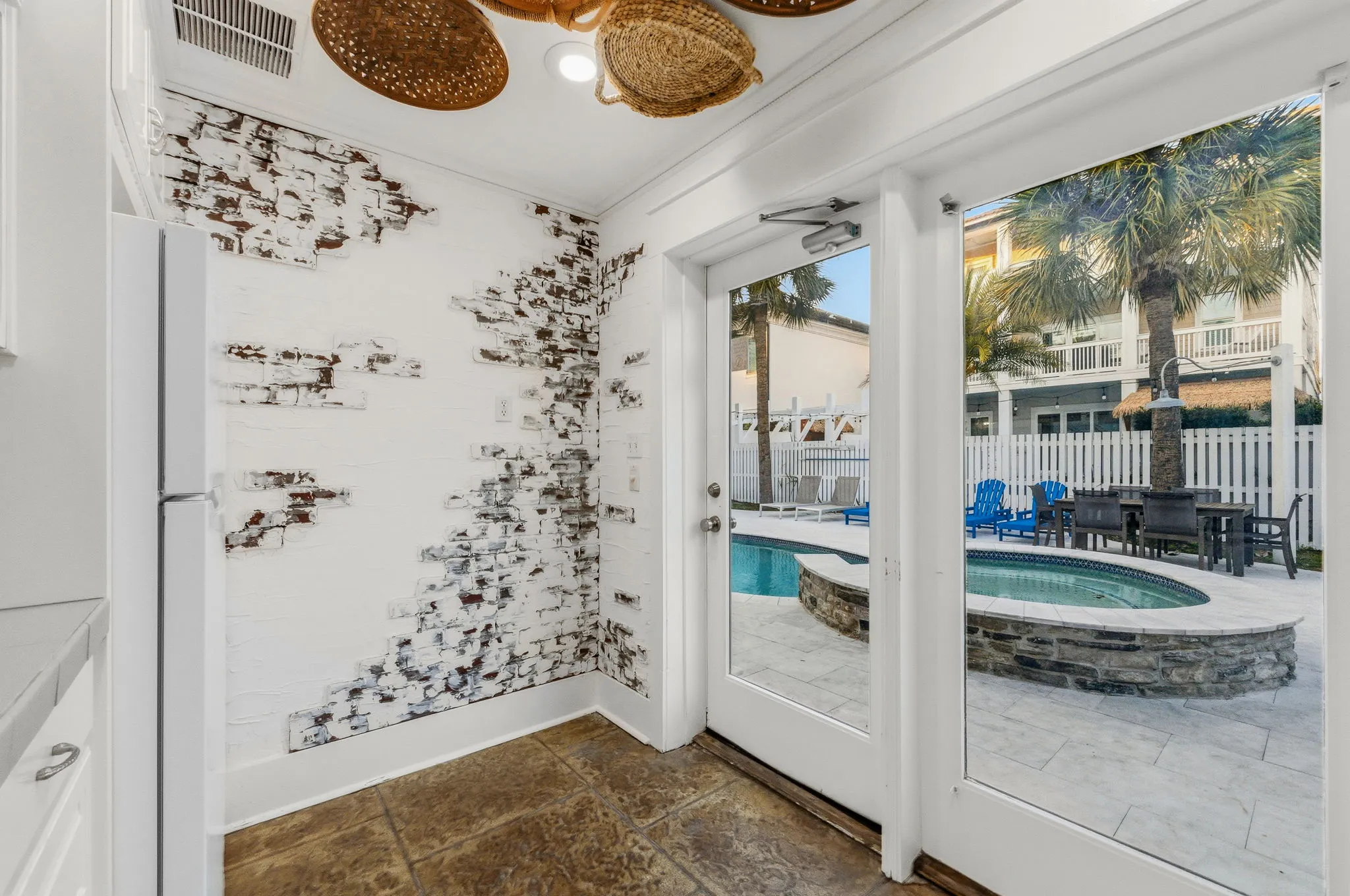 Cabana doorway opening onto the pool, hot tub, and outdoor dining