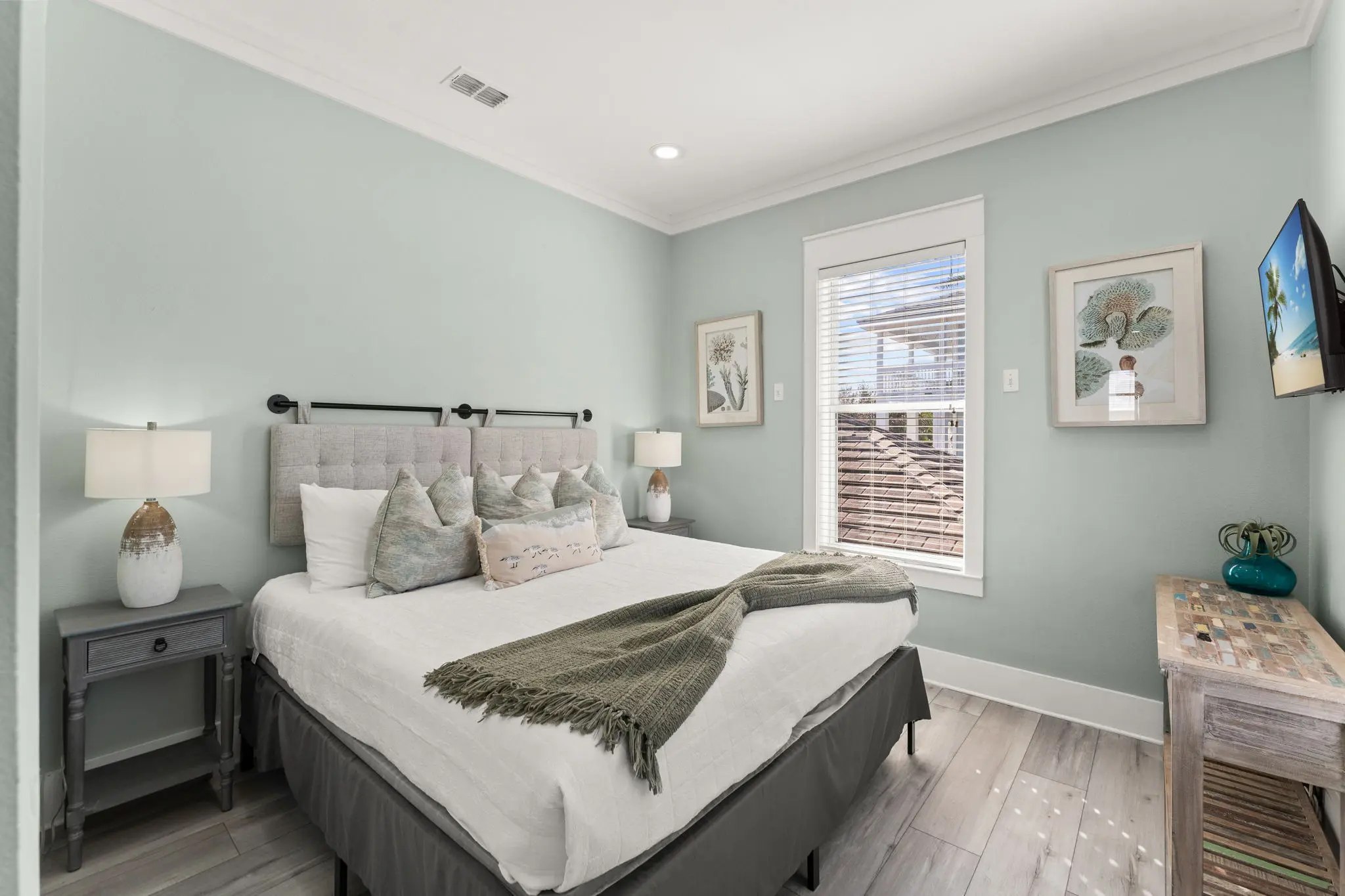 Upstairs king bedroom with botanical and sandpiper art